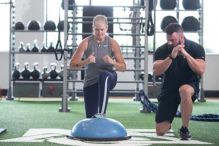 Personal Trainer and client performing a lunge